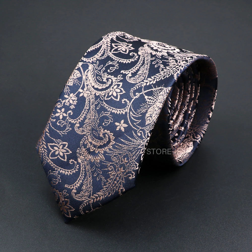 Blue paisley patterned tie on a dark background