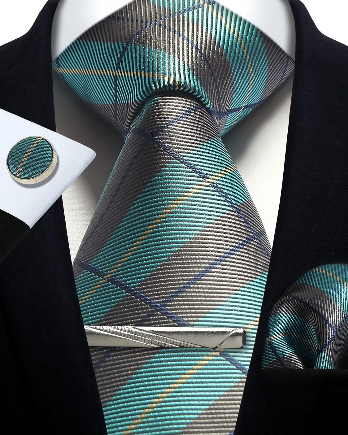 Teal and gray plaid tie with matching pocket square and cufflinks on a black suit.