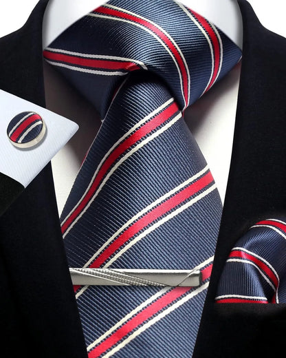 Navy blue tie with red and white stripes, cufflinks, and pocket square on a black suit.