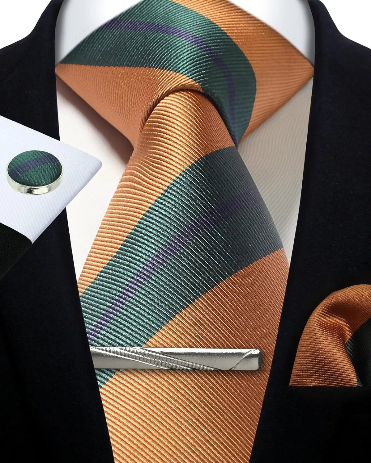 Orange and green striped tie with a tie clip on a white shirt against a black jacket background.