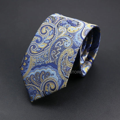 Blue and gold paisley patterned tie on a dark gray background