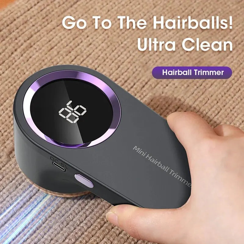 Hairball trimmer with digital display held by a hand on a textured surface