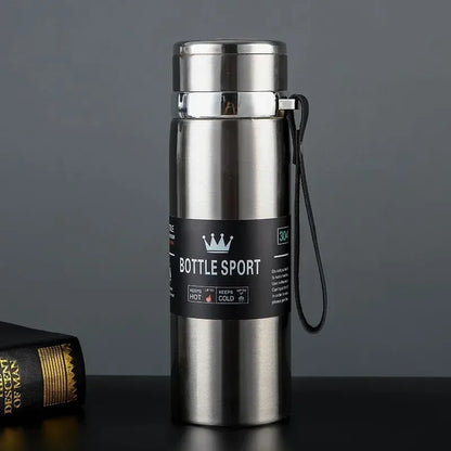 Stainless steel bottle with a label on a dark surface