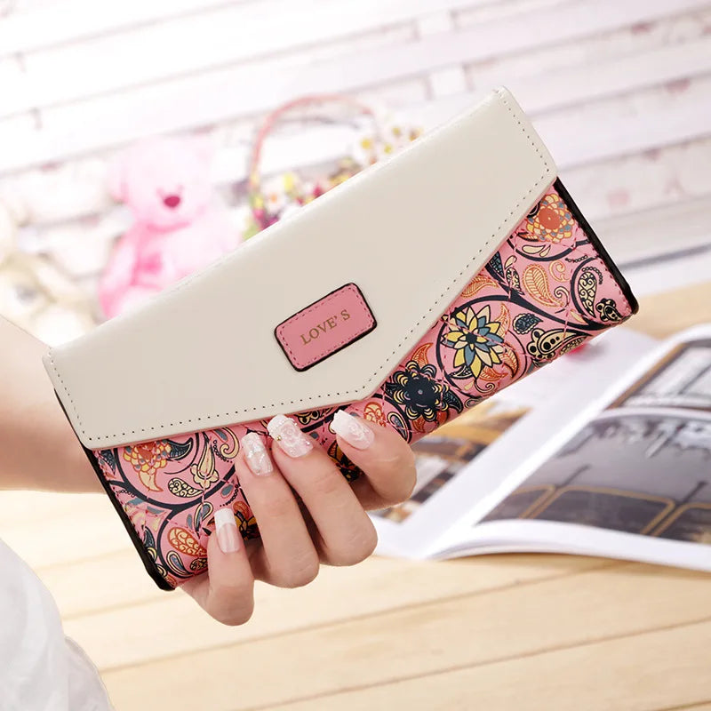 pink wallet with a colorful pattern and 'LOVE' label.
